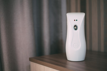 Automatic white air freshener on the chest of the house