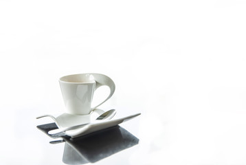 A cup of coffee on glass table on white background.