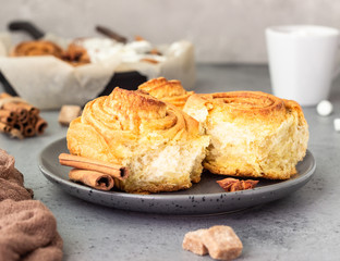 Cinnamon rolls (Cinnabon) on a plate with hot chocolate or cocoa drink. Kanelbullens dag.