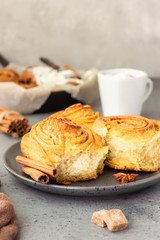 Cinnamon rolls (Cinnabon) on a plate with hot chocolate or cocoa drink. Kanelbullens dag.