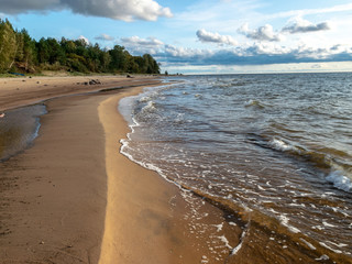 seascape image of the sea with cloudy sky before sunset,  stones and  of light before sunset, beautiful sunny day and quiet sea. baltic sea, Tuja beatch, Latvia