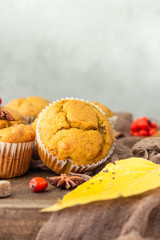 Sweet pumpkin or carrot muffins with fall spices. Autumn dessert. Healthy baking concept. Copy space.