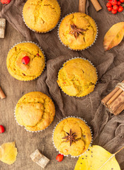 Sweet pumpkin or carrot muffins with fall spices. Autumn dessert. Healthy baking concept. Copy space.