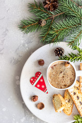Italian homemade biscotti cookies or cantuccini with hazelnuts and a cup of coffee. Grey background. Christmas or New year concept.