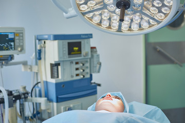 Several doctors surrounding patient on operation table during t