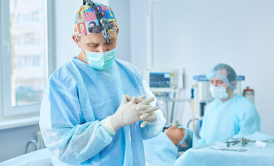 Several doctors surrounding patient on operation table during t