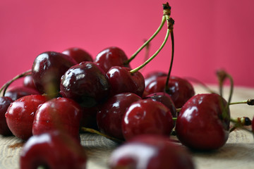 Cherries with water drops on wooden table