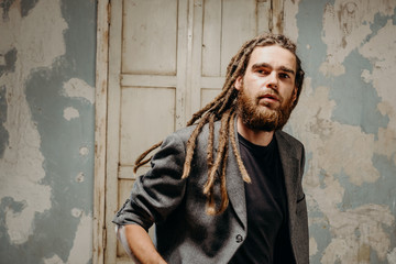 Emotion male portrait of man with dreadlocks in theater studio.