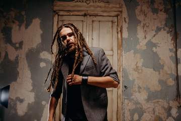 Emotion male portrait of man with dreadlocks in theater studio.