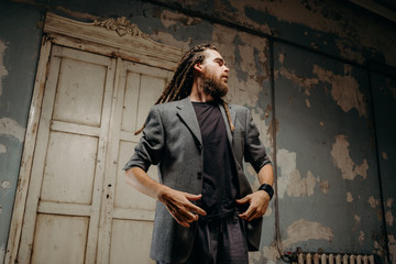 Emotion male portrait of man with dreadlocks in theater studio.