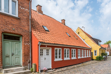colourful houses on an old  street with cobblestone in the danish island Aero