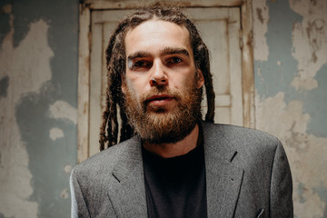 Emotion male portrait of man with dreadlocks in theater studio.