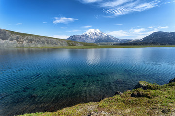 Volcano and lake with reflection in water in Russia on Kamchatka