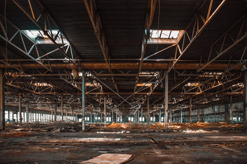 Ruined and abandoned industrial hall of warehouse or hangar in process of reconstruction