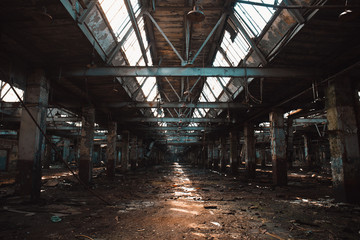 Ruined and abandoned industrial hall of warehouse or hangar in process of reconstruction
