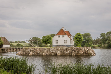 Fototapeta na wymiar the beautiful manor house Søbygaard behind reed and moat in the island of Ærø in Denmark