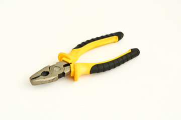 metal pliers with rubber handles black and yellow color isolated on white background. Repair or building concept