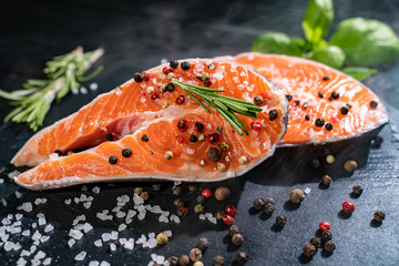Fresh salmon with spices and lemon on wooden table