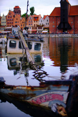 Fototapeta na wymiar Boat wreck in the marina of Gdańsk (Danzig in German) a port city on the Baltic coast of Poland