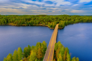 Aerial view of the island of Rapeikko and Ihantsalo on a blue lake Saimaa. Landscape with drone. Blue lakes, islands and green forests from above on a cloudy summer morning. Lake landscape in Finland.
