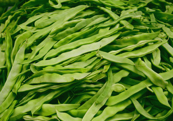 Fresh raw green haricot pods at the market. Organic product suitable for vegeterians and vegans.