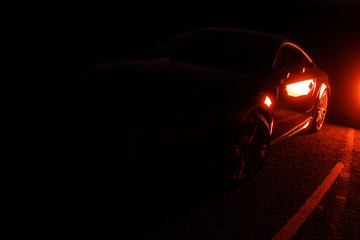 Obraz na płótnie Canvas Dark, moody, automotive background minimalist car shape, RED.