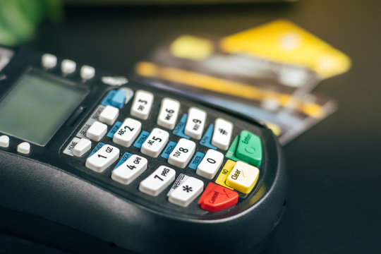 Credit card reader machine or Payment terminal with credit card on table