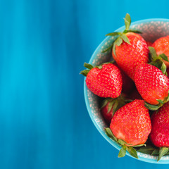 fresh Strawberry in a bowl top view on blue background
