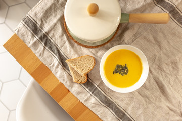 pumpkin cream soup with pumpkin seeds and bread
