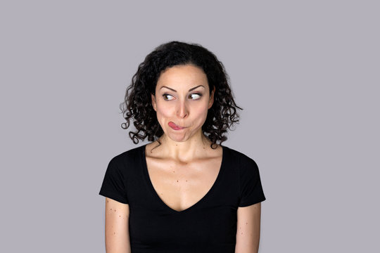  Young woman with the tongue out in a funny gesture