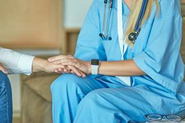 Hand of doctor reassuring her female patient
