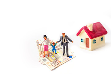 miniature family people standing on stack of 50 euro banknote with tiny home isolate on white background,  Image for real-estate management  concept.