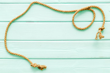 rope frame on mint green wooden background top view mock-up