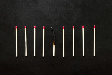 Matches for danger concept on black background top view