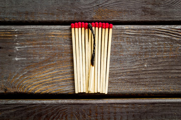 Matches for danger concept on wooden background top view