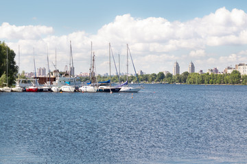 Fototapeta na wymiar Small city marina on river with sailing yachts and boats