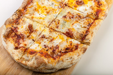 Closeup Pizza Quattro formaggi on a cutting board