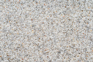 Natural colored marble chips background texture. Decorative marble plaster for indoor and outdoor use. Coarse-grained stone. quartz sand