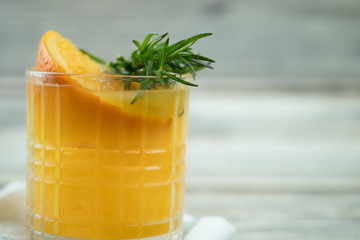 Fresh summer cocktail with orange juice and ice cubes in glass