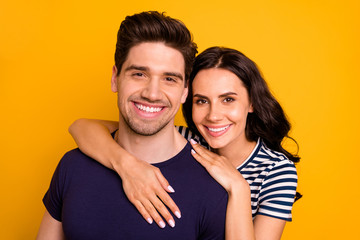 Close up photo of hugging couple toothily smiling beautiful handsome charming fascinating pretty isolated with yellow background