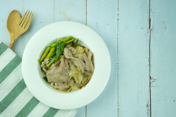 Rice noodles with marinated pork and kale in gravy