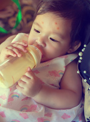 Baby is sleep eating milk from bottle