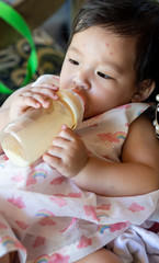 Baby is sleep eating milk from bottle
