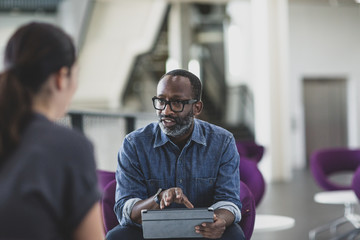 African American businessman using a digital tablet in a meeting