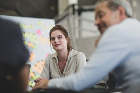 Female executive listening in a brainstorm meeting