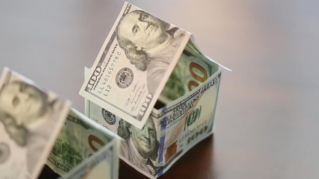 Slow Pan of Houses Built with One Hundred Dollar Bills