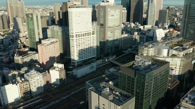 day flying backwards from Shinjuku Tokyo and tilting up revealing NTT Docomo Yoyogi Building