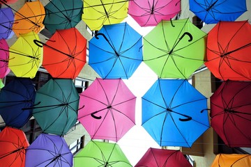 Fototapeta na wymiar beautiful hanging open colorful umbrellas background