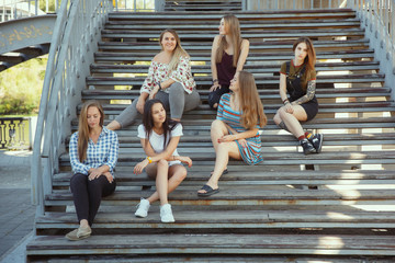 Obraz premium Different and happy in their bodies. Young women smiling, talking, walking and having fun together outdoors on sunny summer's day at park. Girl power, feminism, women's rights, friendship concept.