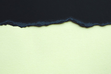 Abstract background and texture. Black torn cardboard and light yellow texture paper...